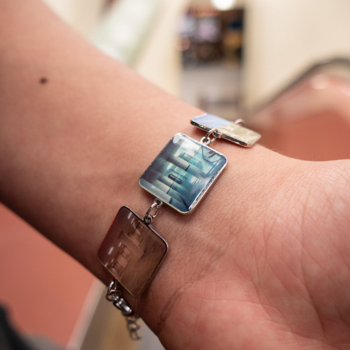 Close-up of Backrooms Bracelet poolrooms charm, UV-printed stainless steel with polished bezel
