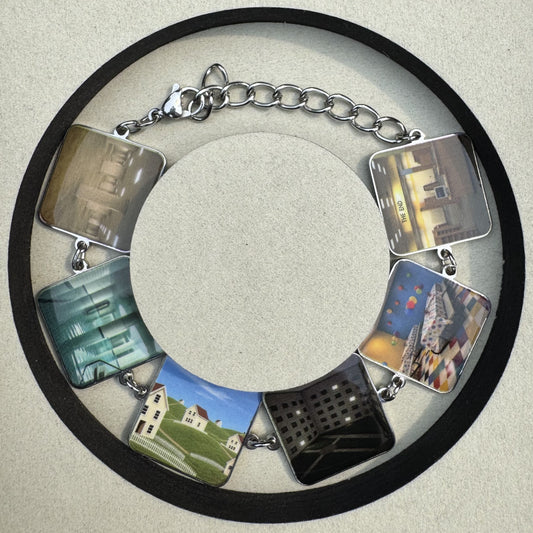 Entry 001 Backrooms Bracelet laid flat, six UV-printed stainless steel charms on a cable chain