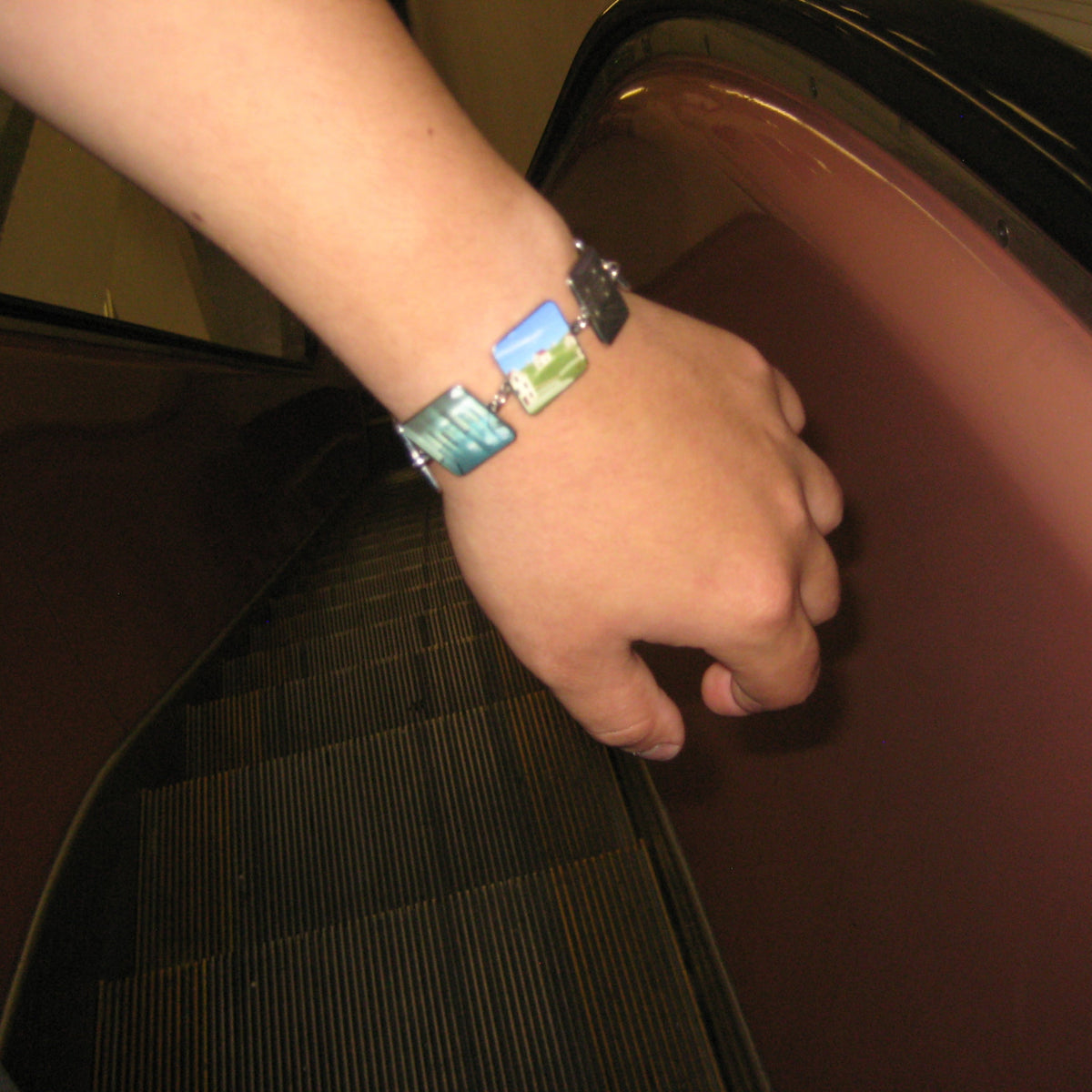 Backrooms Bracelet worn on a wrist on a mall escalator, flash photo